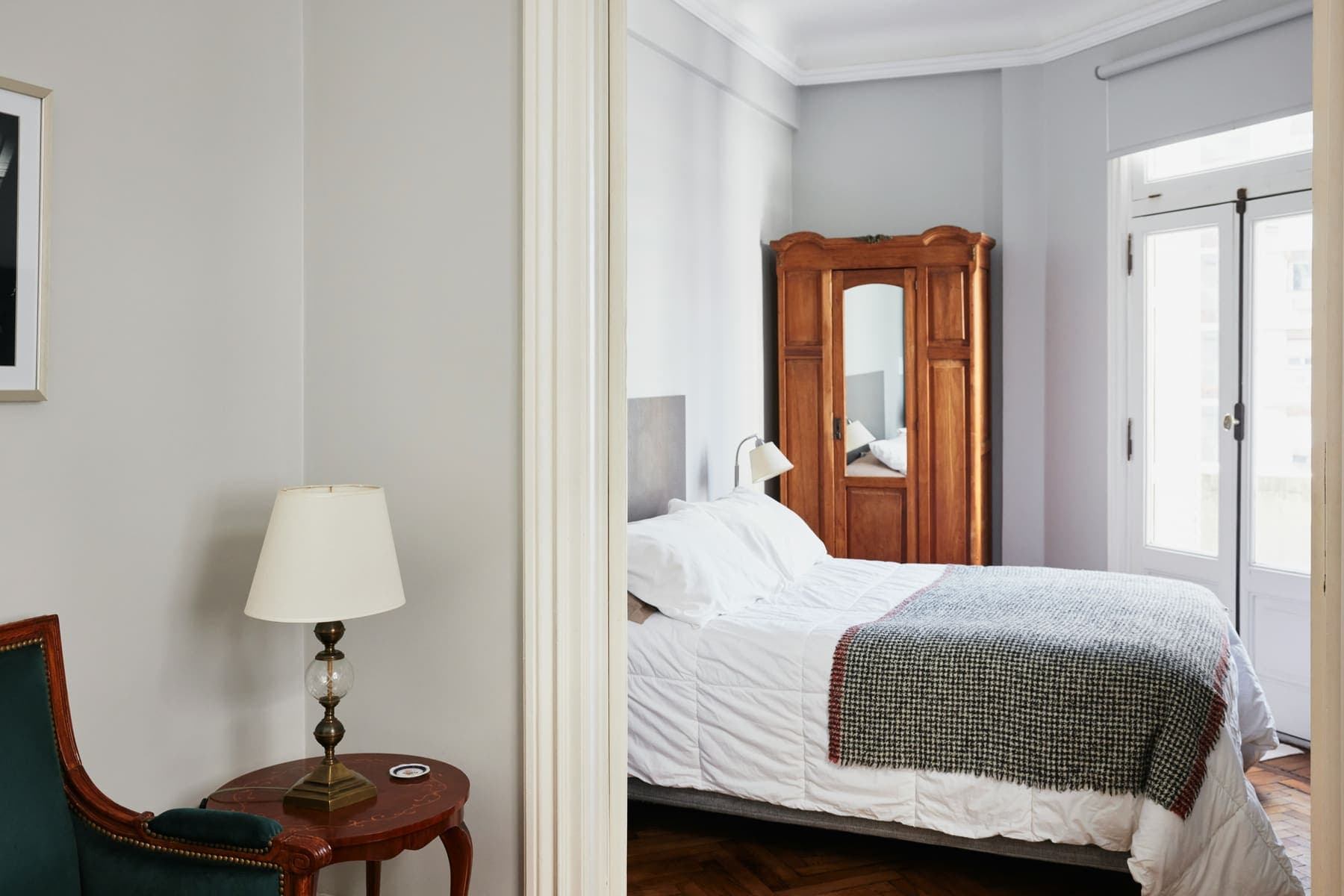 Bedroom with antique armoire through doorway
