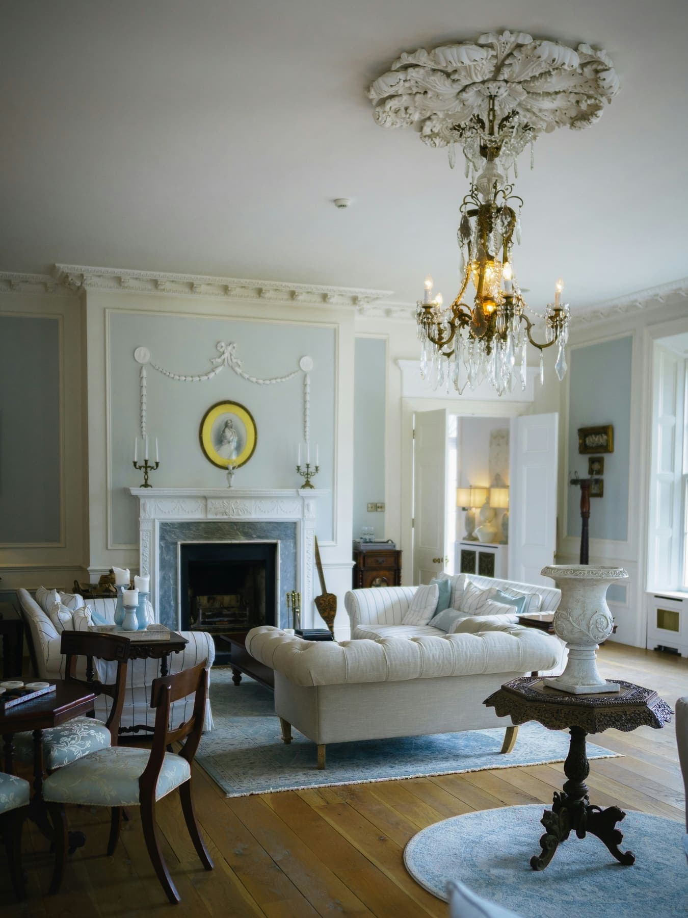 Period drawing room with chandelier and fireplace