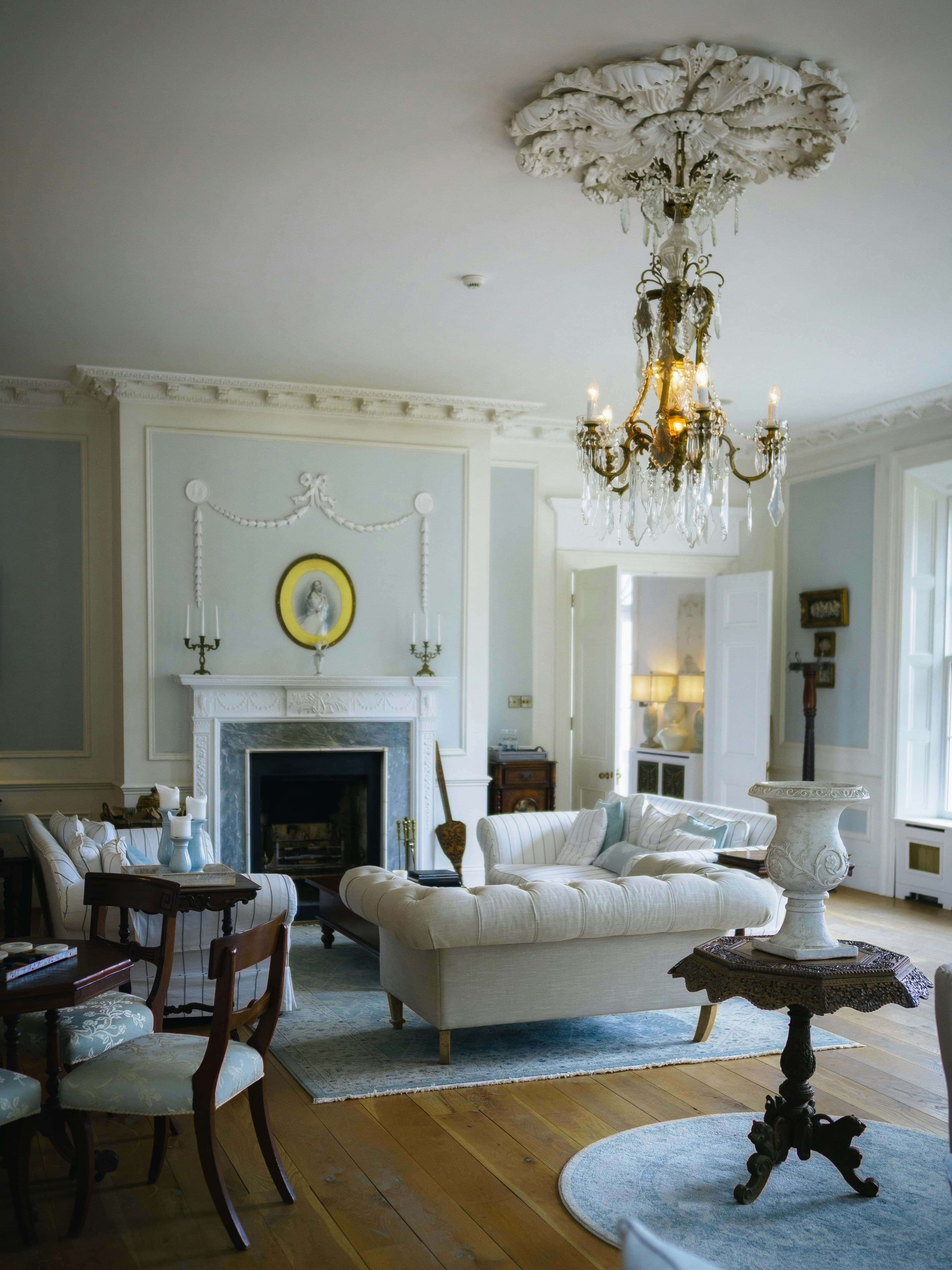 Period drawing room with chandelier and fireplace